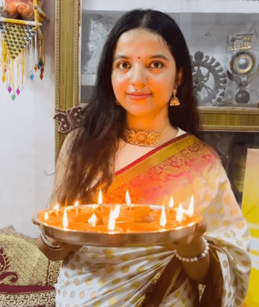 Shivangi in a Diwali sari holding a plate of diyas